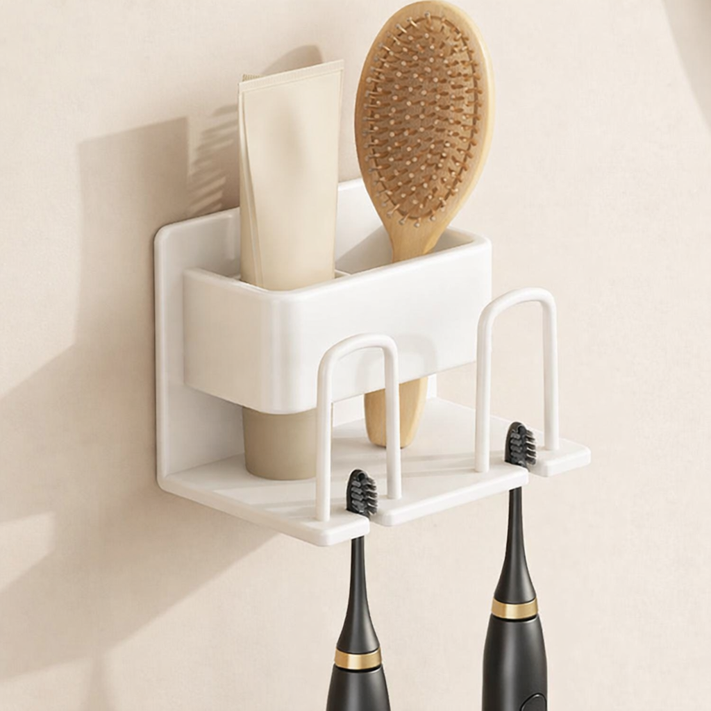 Corner wall-mounted organizer with a hairbrush, comb, and two electric toothbrushes on a neutral background.