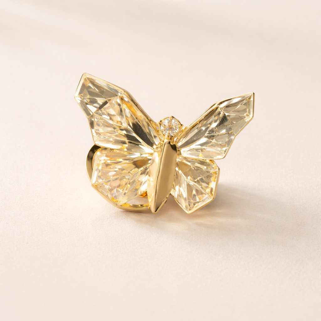 Gold butterfly-shaped object on a beige background