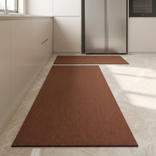 Brown kitchen mats on a light-colored floor with a refrigerator in the background.