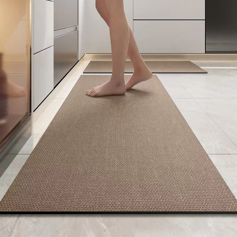 Person walking on a textured brown rug in a modern kitchen.